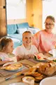 A girl smiling with food inside the glamping bell tent