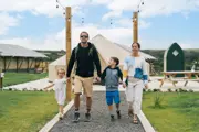 A family walking around the camping and glamping site at Camel Creek