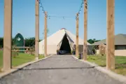 A photo of the outside of the bell tent with path 