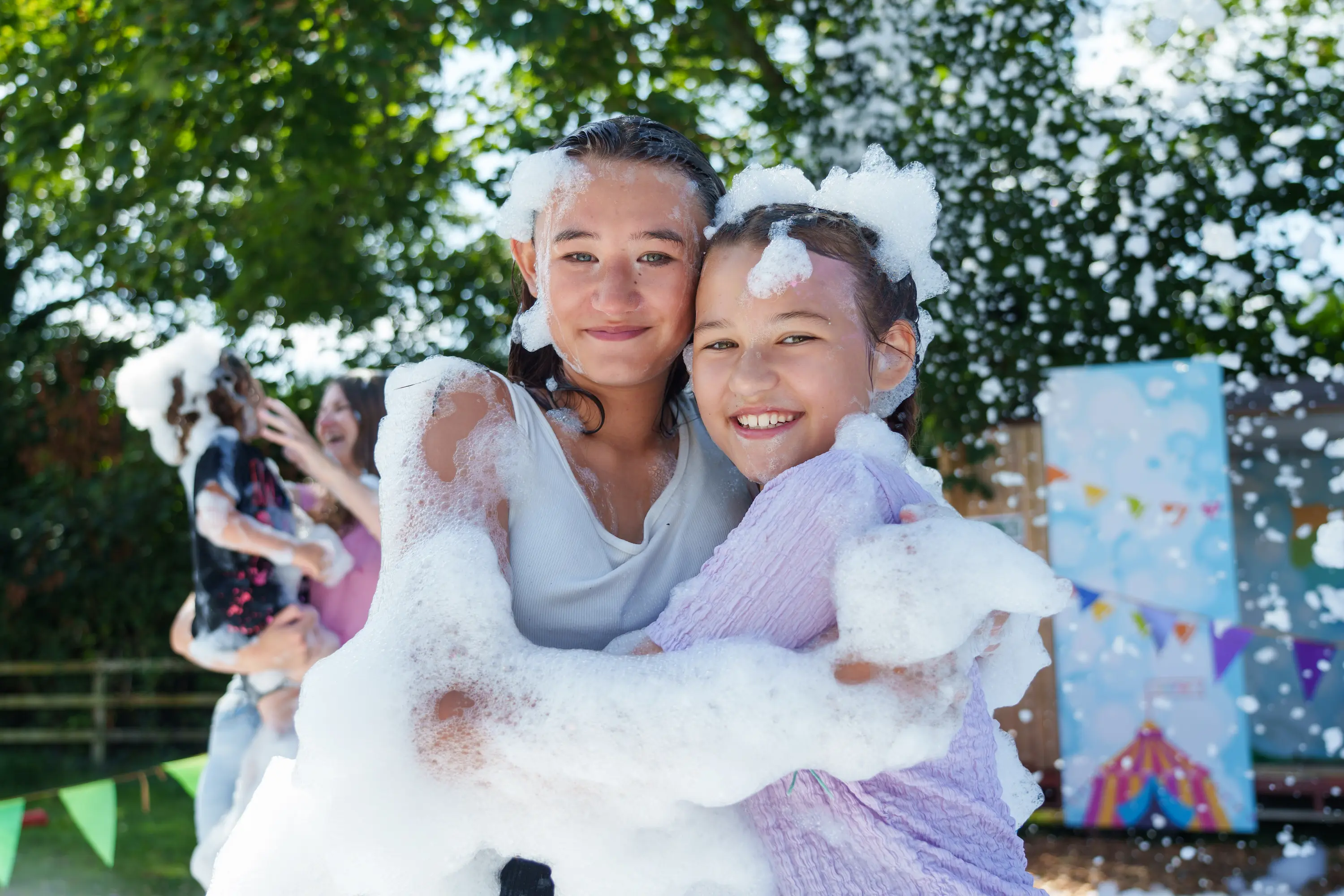 Two girls covered in foam at Kids Fest 