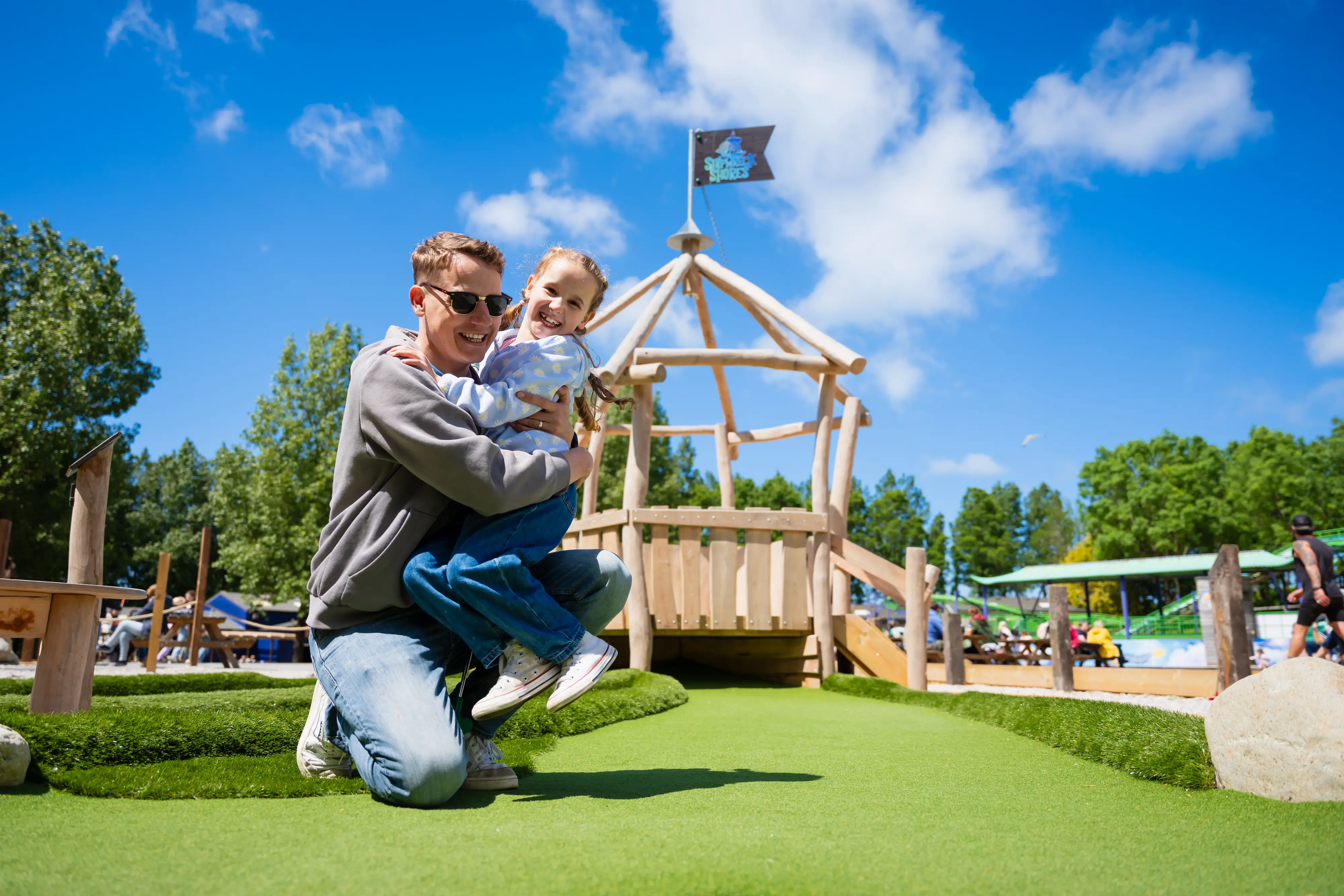Girl and dad playing adventure golf