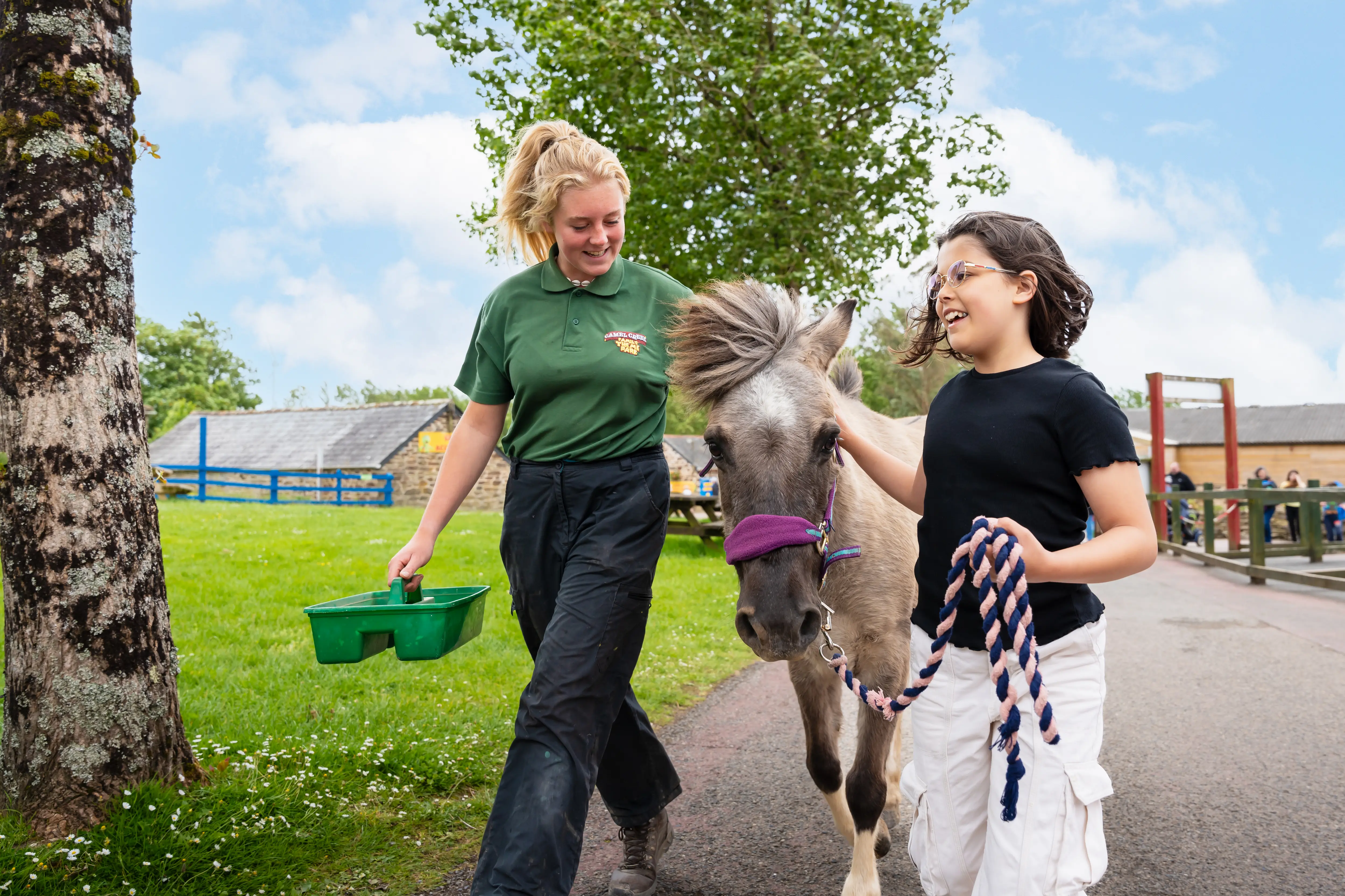 Girl and staff member with horse doing junior keeper experience 