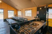 Dining area and kitchen inside a safari lodge 