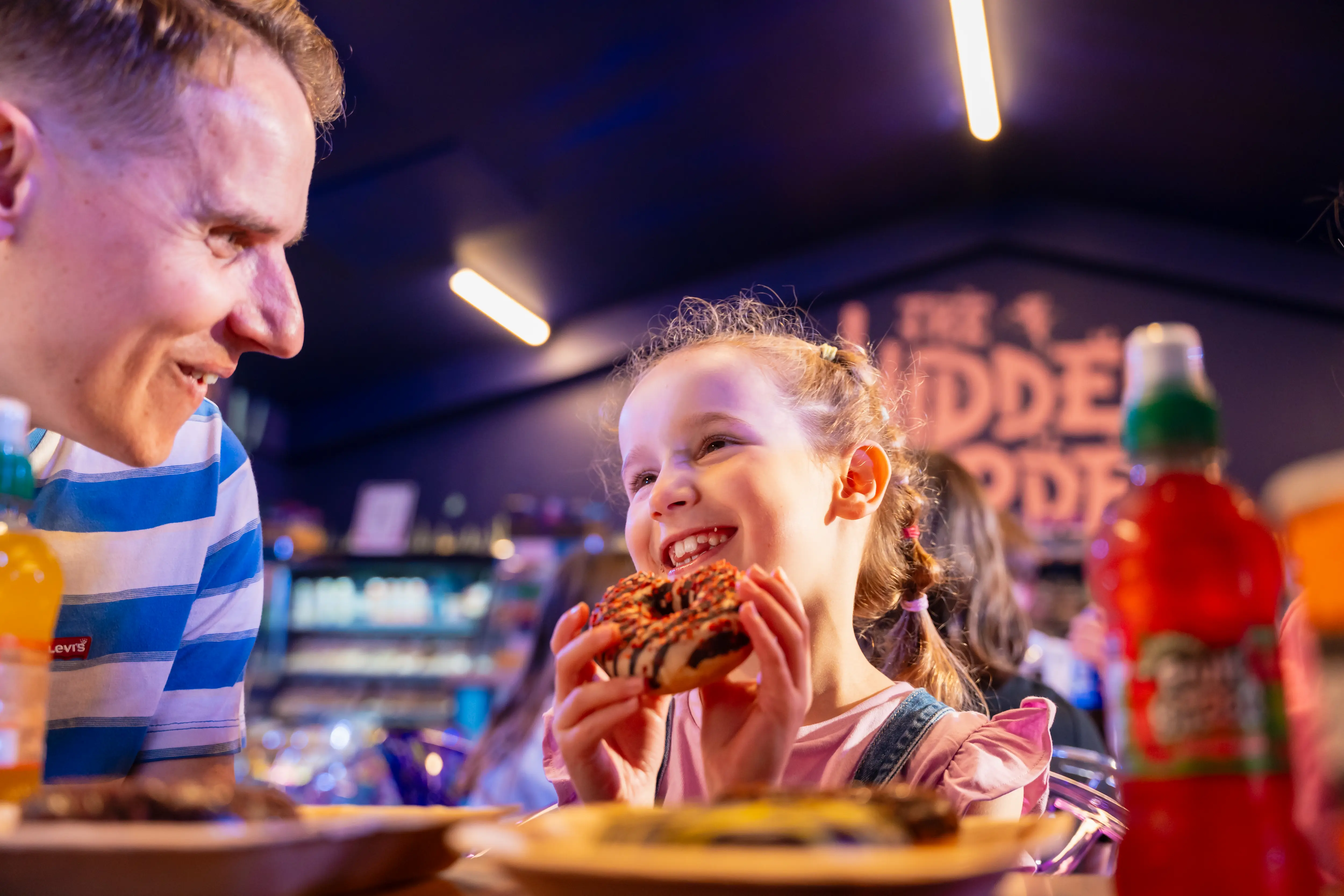 Child eating donut at Hidden Garden Cafe 
