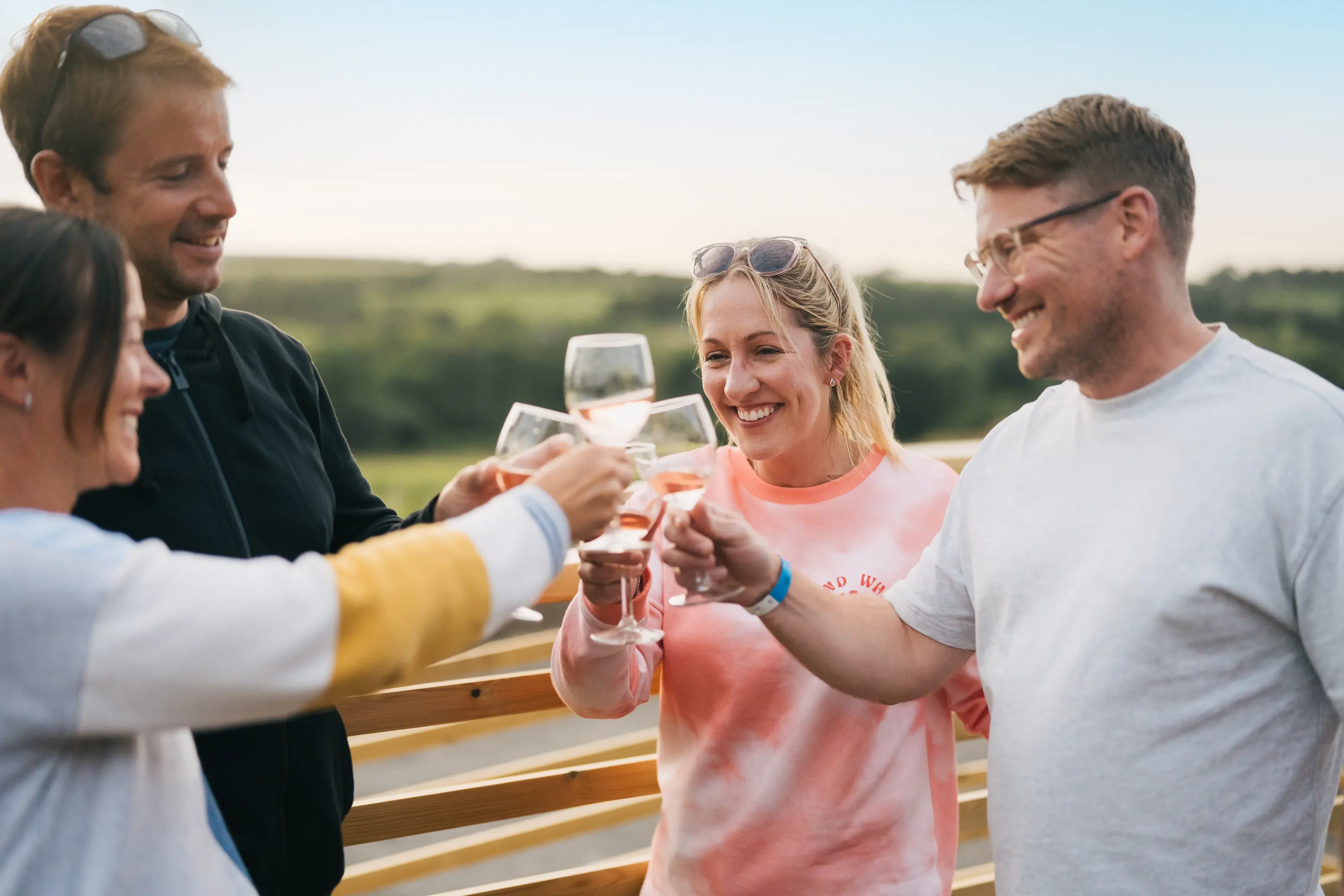 Friends cheersing their glasses at the camping and glamping site