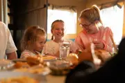 A family laughing inside the glamping bell tent