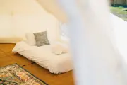A single bed inside the glamping bell tent at Camel Creek 