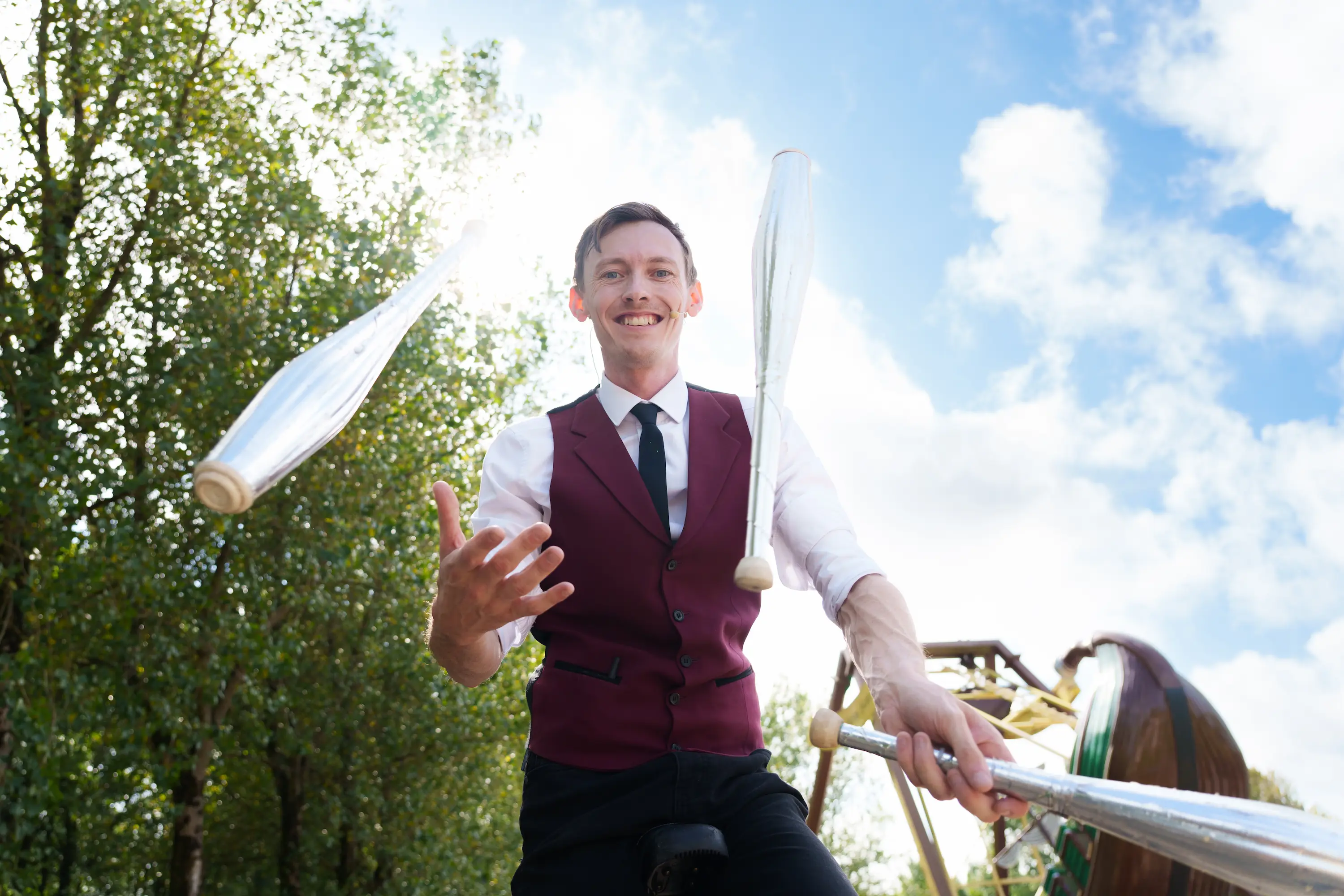 Man juggling with baseball bats